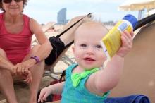 baby holding sunscreen